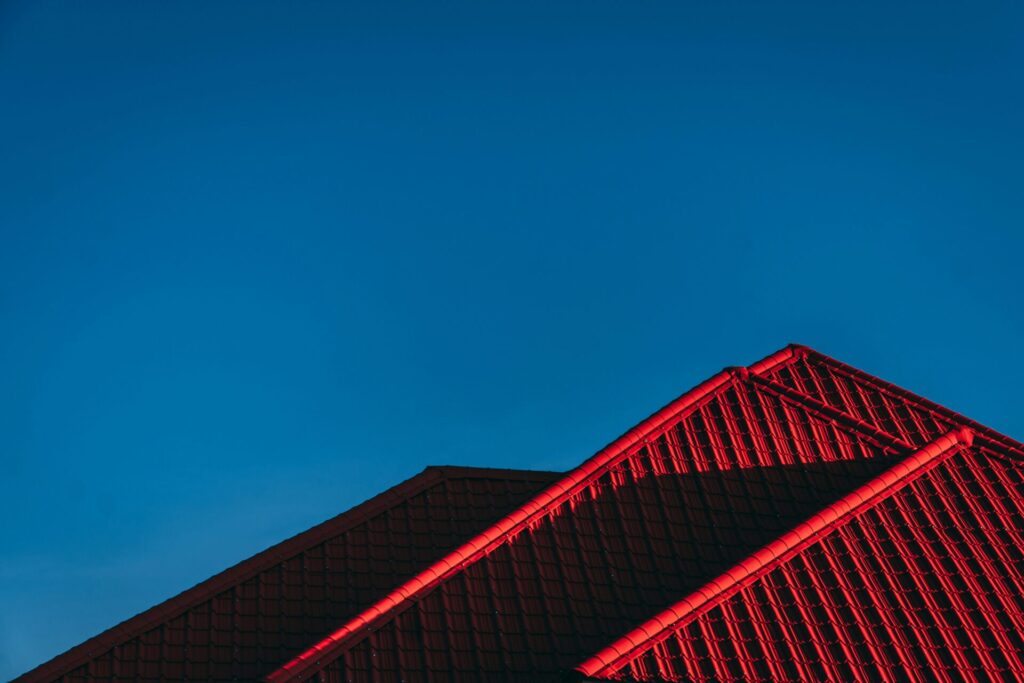 A fancy red metal roof illuminated by sunlight