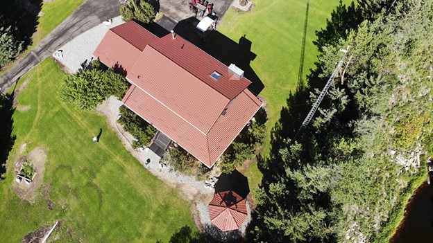 View of a house with a brown metal roof.