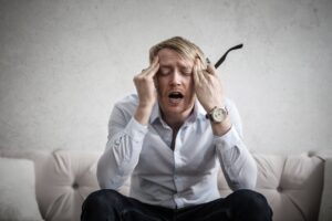 A man touching his head