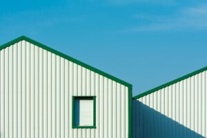 White metal siding with green edges on a building