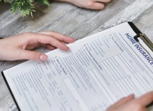 A home insurance document on a wooden surface